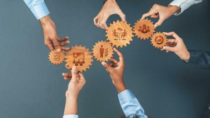 mains présentant des engrenages en bois